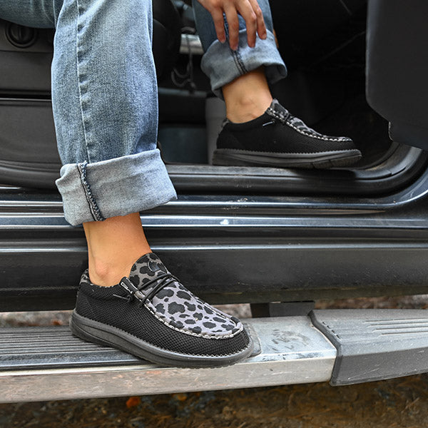 Woman stepping out of truck wearing Camp Shoes in Shadow Leopard